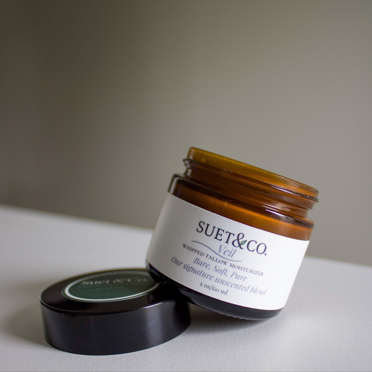 Jar of Suet & Co. product on a neutral background