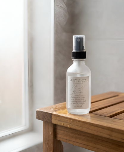 Moonlit Hollow aromatic shower mist sitting on a wooden bench in the shower steam